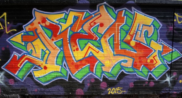 tag in reds, oranges and yellows, on green, with dark blue background