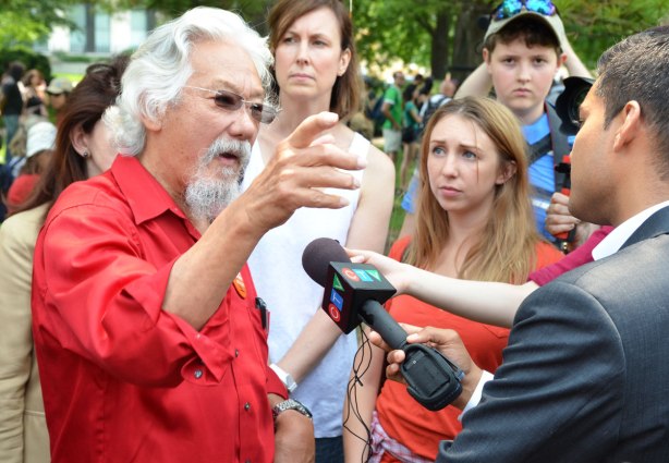David Suzuki is being interviewed by a man from CTV.  A few people are standing behind. 