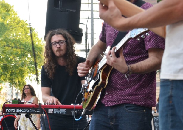 keyboard player in Conor Gains band playing at Streetfest at the Beach, Queen St. in Toronto in July, summer evening