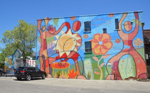large mural of stylized people, 2 people, a drummer and a dancer