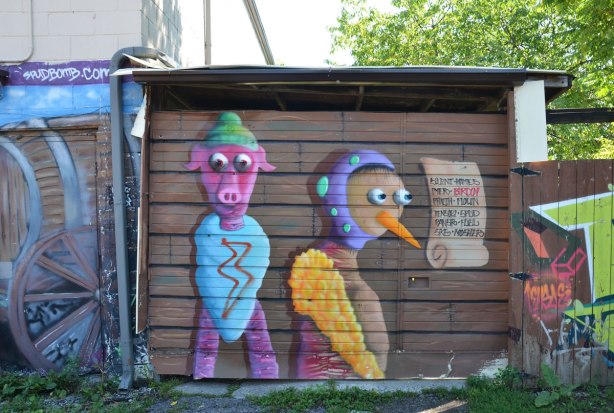Two birdo creatures on a brown garage door