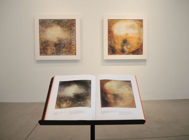 An open book on a pedestal, a large picture of a painting on each page. Two paintings on a wall directly behind the book. The paintings on the wall are replicas of the ones in the book .