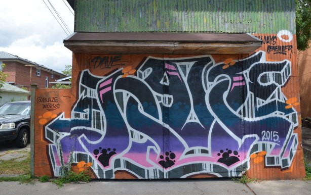 blaze works tag like graffiti street art on a garage door in an alley