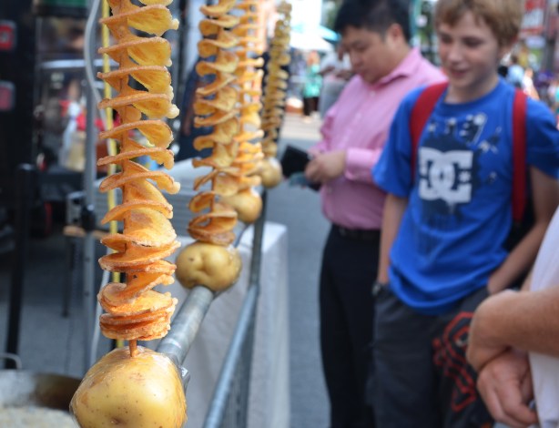 deep fried twisted potatos for sale at an outdoor festival