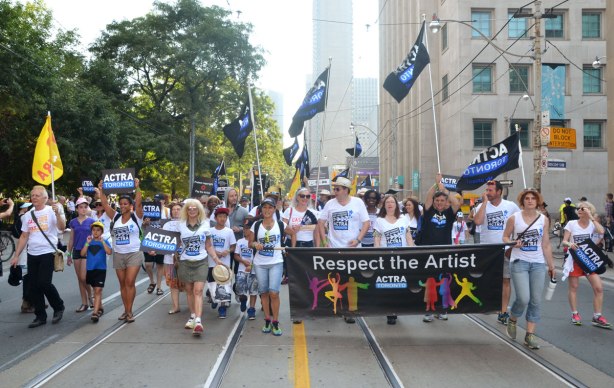 Labour day parade - ACTRA group walking behind a banner that says respect the artist 