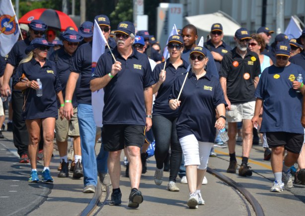 men and women from IBEW (electrical workers) walk in a labour day parade