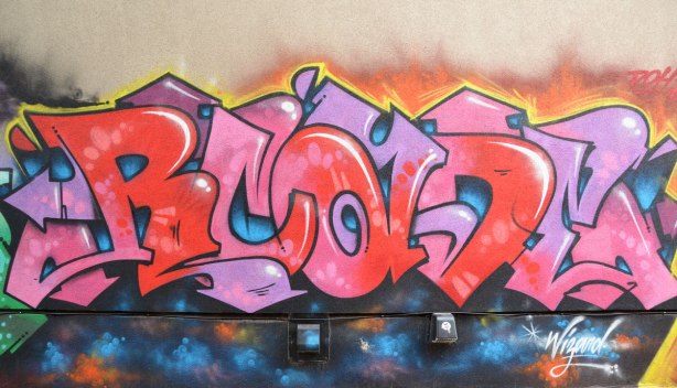 Street art in pinks and reds, signed by Wizard