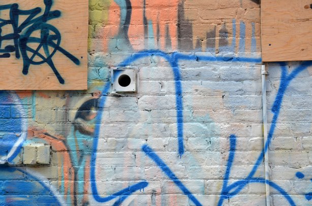 Just an eye from a previous street art painting hasn't been covered by a white tag