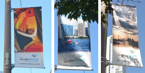 A composite of three pictures, each of a vertical banner hanging from a pole outdoors along a street. One banner is a kayaker in the harbour in front of the Toronto skyline. Another is a sunset over Toronto skyline on a cloudy day