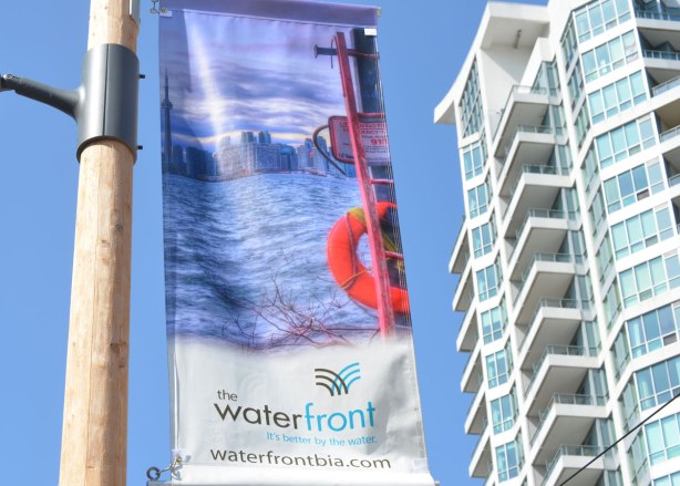 Picture of round orange life ring on the edge of the waterfront in Toronto.