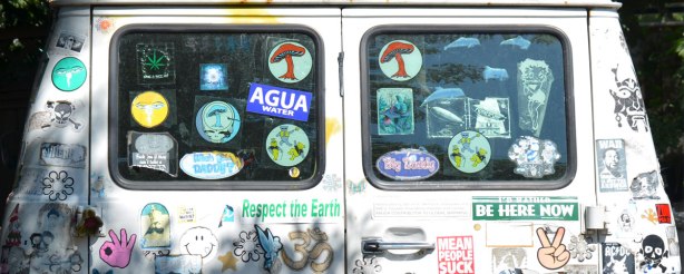 back windows of a chevy van covered with stickers
