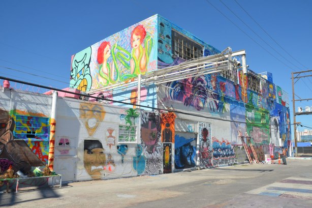 exterior wall of a two storey building that has been covered with street art by a number of different artists