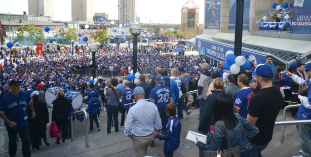 Before a Blue Jays baseball game at the ROgers Centre - many people on the stairs to the east of the stadium, and many people waiting in the square below, trying to get into the stadium through gate 6. 