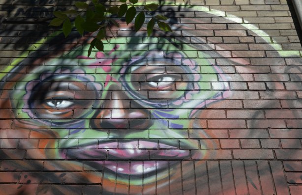 close up a street art face on a wall