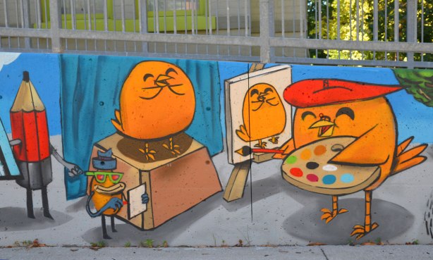 part of a mural by Uber5000 with birdie in paiter's beret holding a paint palette and painting a portrait of another bird who is posing on a table beside him. 