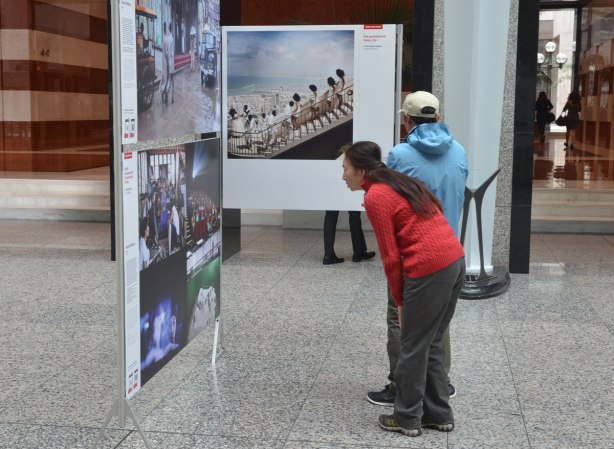 people looking at photographs, the winning pictures from the World Press Photo contest, on display at Brookfield Place 