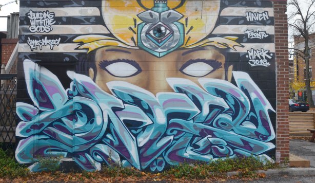 Blue curvy lines on the bottom, a pair of blank white eyes in the middle and a scarab like creature in the middle of the top section. 