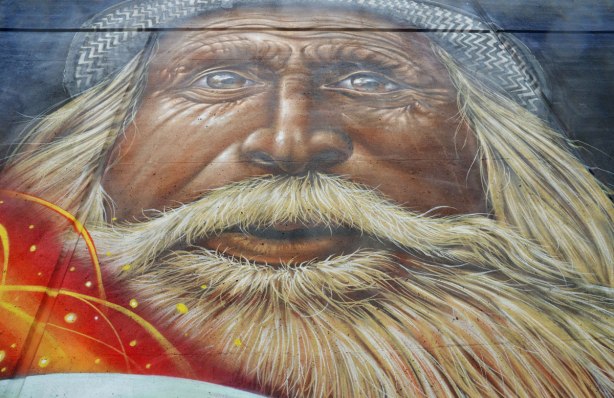 part of a larger mural on an underpass in Toronto, on Lawrence West, a close up of an old bearded man's face. 