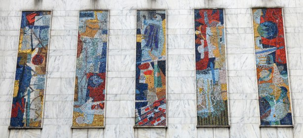 five vertical panels of mosaic in bright colours on an exterior wall