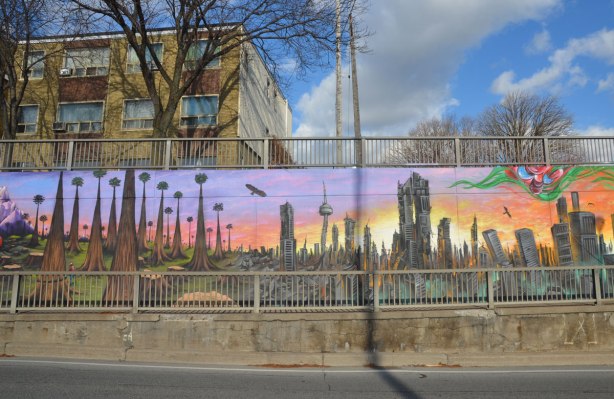 part of a mural by Essencia Art Collective on Lawrence West in Toronto showing the drastic possible environmental effects of not looking after the planet - dead forest, dead city