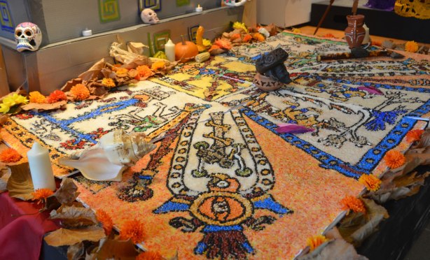 pictures made of coloured rice on an ofrenda dedicated to the indigenous people of Mexico