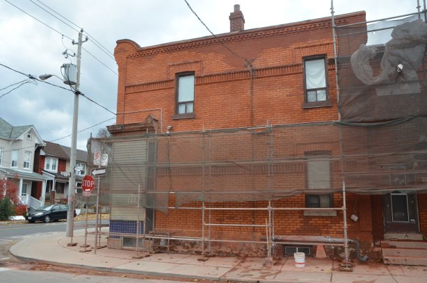 An old square two storey brick house undergoing restoration. 