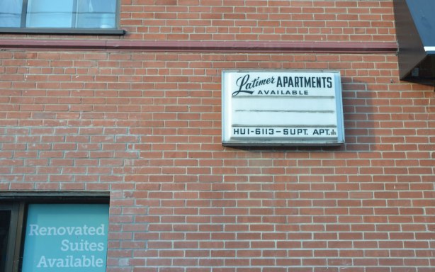 old sign on the side of an small apartment building, the Latimer Apartments, with an old Toronto phone number starting with the letters HU
