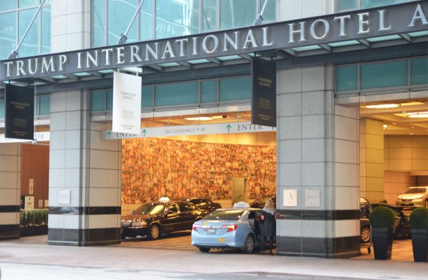 parking entrance and valet parking at Trump International Hotel in Toronto. A blue taxi has just pulled in, a yellowish hue in the interior of the space