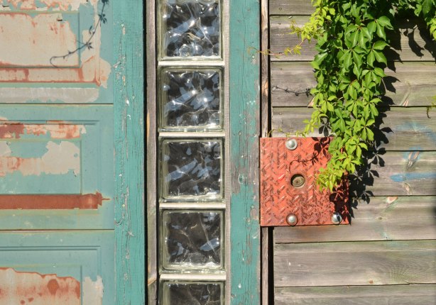 abstract composition of wood panelling, glass panes and painted wall