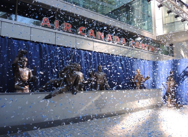 Legends Row at the unveiling of statues of Syl Apps and George Armstrong, lots of bits of blue and white paper stream down in front of the statues. 