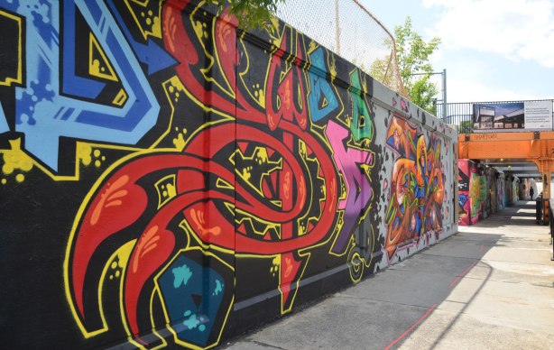 part of a large collection of street art paintings on a wall of a railway underpass on Bloor St. West 