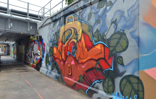 part of a large collection of street art paintings on a wall of a railway underpass on Bloor St. West 