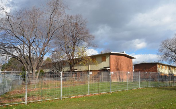 rowhouses boarded up and fenced off in preparation for demolition 