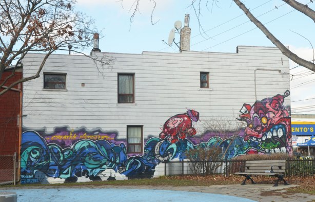 creative monsters mural on the side of a white building beside Sorauren Park