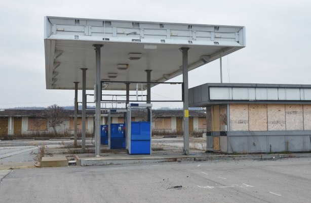 three abandoned fuel pumps at an old unused gas station 