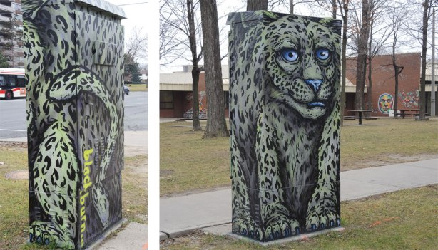 A metal box on a street corner, a leopard by street artist blackburn