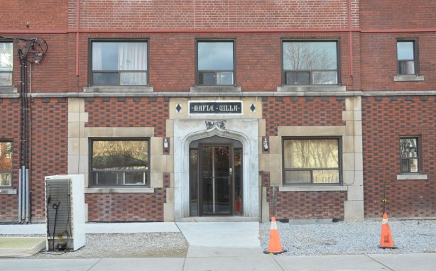 Stone door frame and entranceway to Maple Villa, a brick low rise apartment complex
