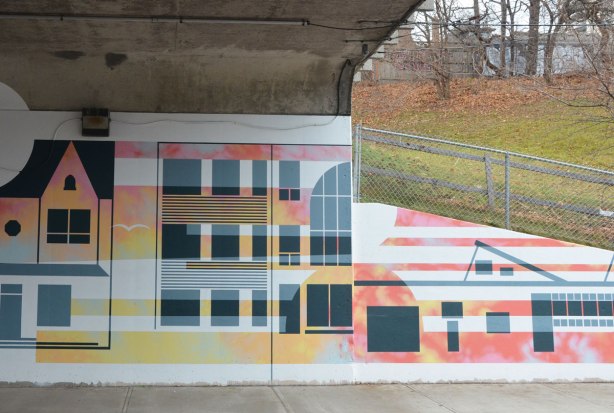 part of a mural by Rob Matejka and Tommy Matejka on the wall on a TTC subway underpass at Keele, a mural of houses on a street