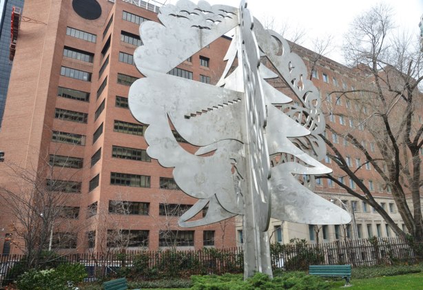 large stainless steel tree sculpture by Michael Snow, consisting of three planes intersecting. 14 metres high, in a small park