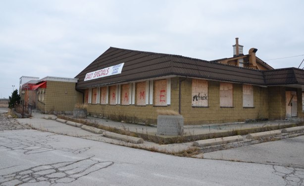 abandoned restaurant stop 50 with boarded windows. Still has a sign that says daily specials