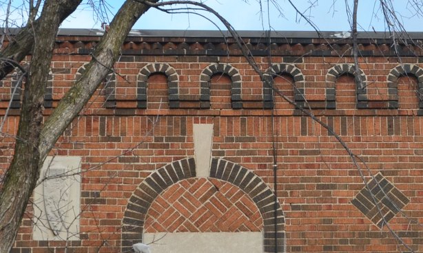 brick pattern across the top of a building. scalloped, or looking like little arches to match the larger arches over the windows. 