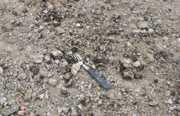 an old fork lies in the gravel 
