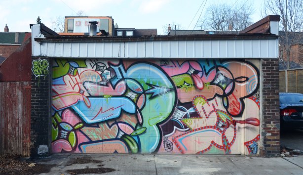 spudbomb mural on a garage door. 