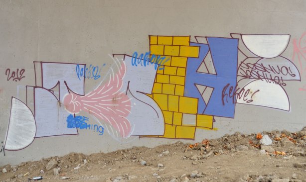 graffiti on concrete bridge supports, block letters