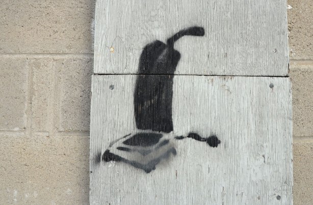 black stencil of an old fashioned upright vacuum cleaner