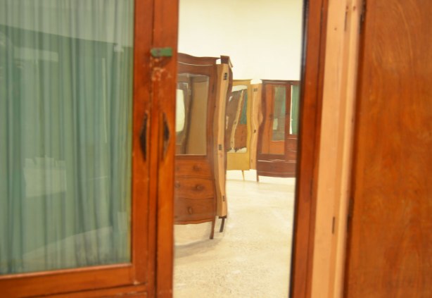 part of an art installation by Chinese artist Song Dong using vintage wooden wardrobe doors with mirrors and curtains, reflections