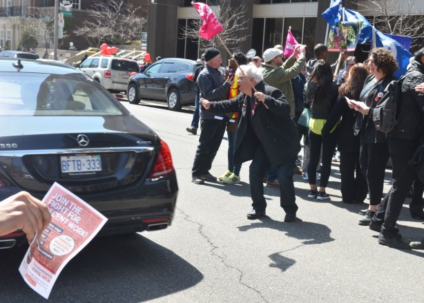 photographs taken at a rally and protest in support of a $15 minimum wage, The Fight for 15 and fairness - a car passes by the rally and as it does, people try to persuade the driver to honk his horn. 