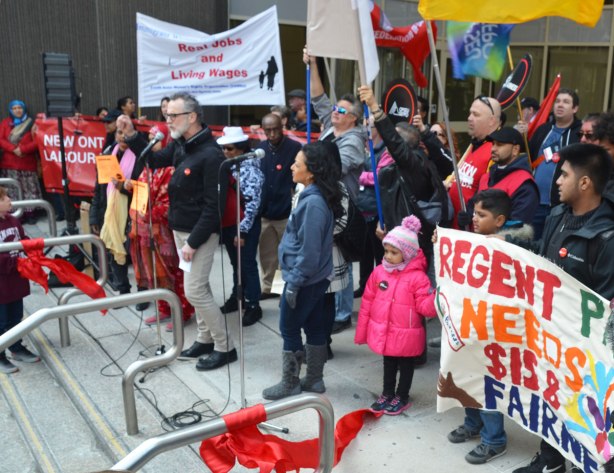 photographs taken at a rally and protest in support of a $15 minimum wage, The Fight for 15 and fairness - speakers and a few people holding signs at the top of the stairs, using that part as a stage