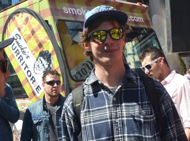 People at Yonge Dundas Square in Toronto celebrating 420 day - 4 young men, one of whom has yellow reflective sunglasses on. 