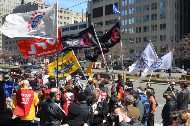photographs taken at a rally and protest in support of a $15 minimum wage, The Fight for 15 and fairness - people, many different union flags